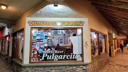 Pulgarcito - Fachada de restaurante Pulgarcito, gran ventanal que deja ver el interior y paredes con revestimiento de piedras em la parte inferior.
